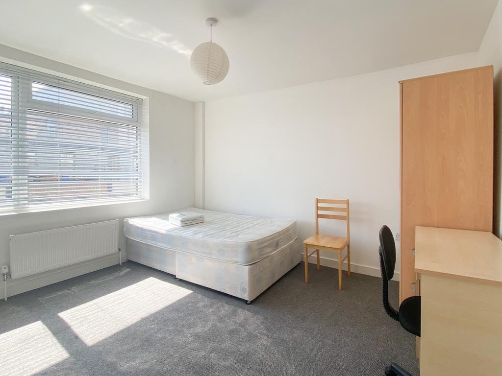 Bright and clean bedroom featuring a comfortabl...