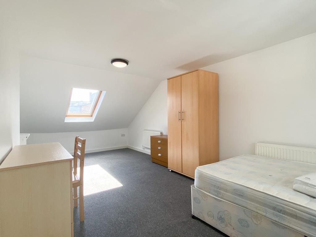 Bright and tidy bedroom with a comfortable bed,...