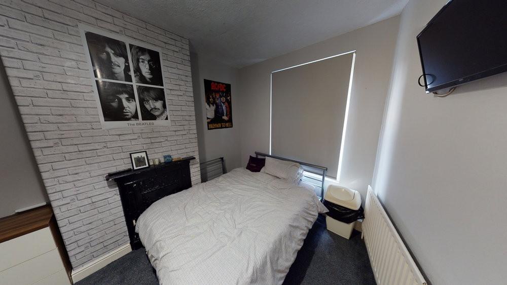 A comfortable double bedroom featuring a cozy b...