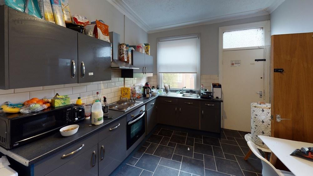 A functional and well-lit kitchen area featurin...