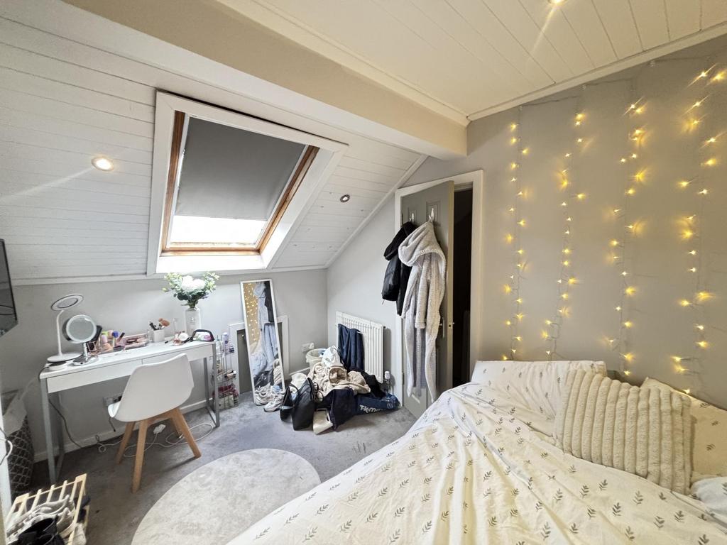 A spacious and inviting master bedroom with a c...
