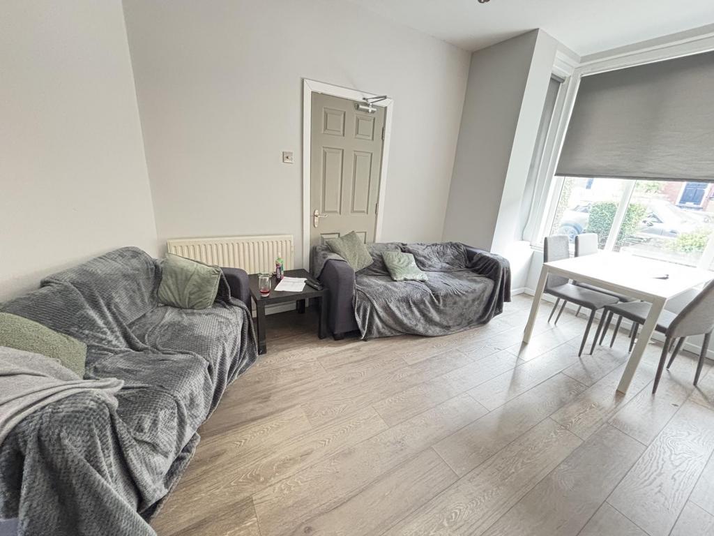 A bright, modern living room featuring comforta...