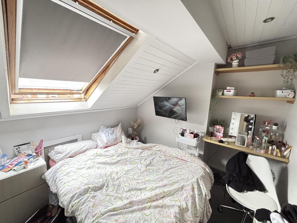 A bright and cozy bedroom featuring a double be...