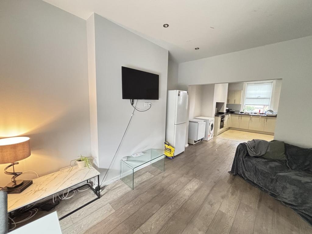 A spacious and well-lit contemporary living roo...