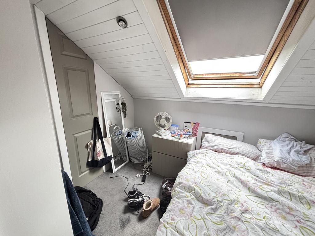 A bright and cozy bedroom featuring a double be...
