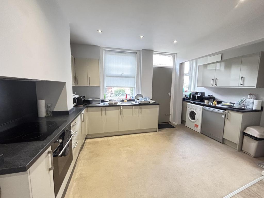 Bright and modern kitchen with ample white cabi...