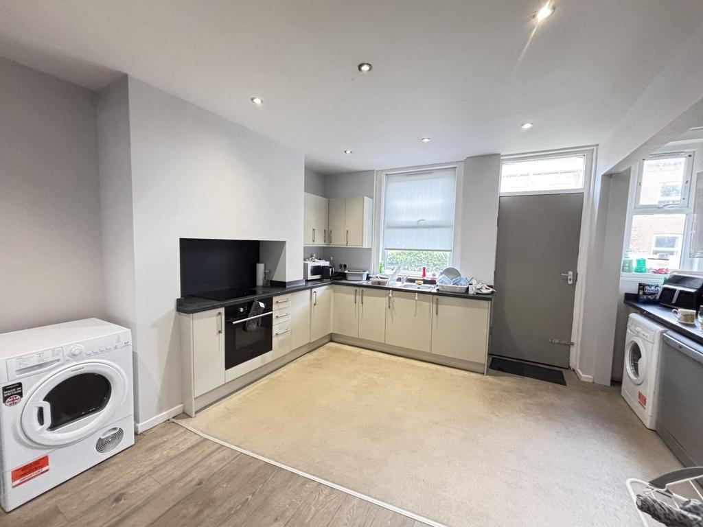 A bright and modern kitchen with ample natural ...