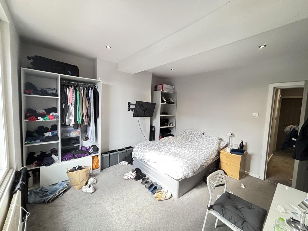 Bright and spacious master bedroom featuring a ...