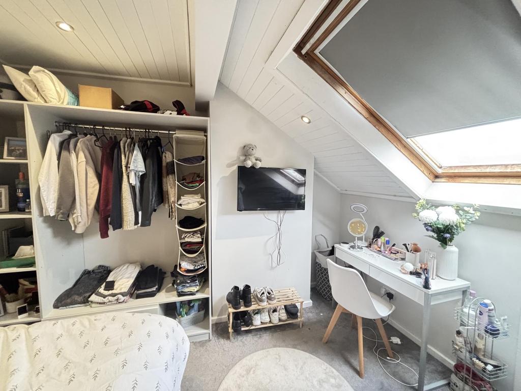 A cozy bedroom with a neatly organized wardrobe...
