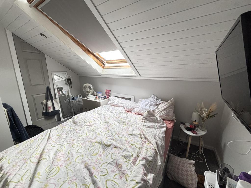 A spacious, well-lit master bedroom featuring a...