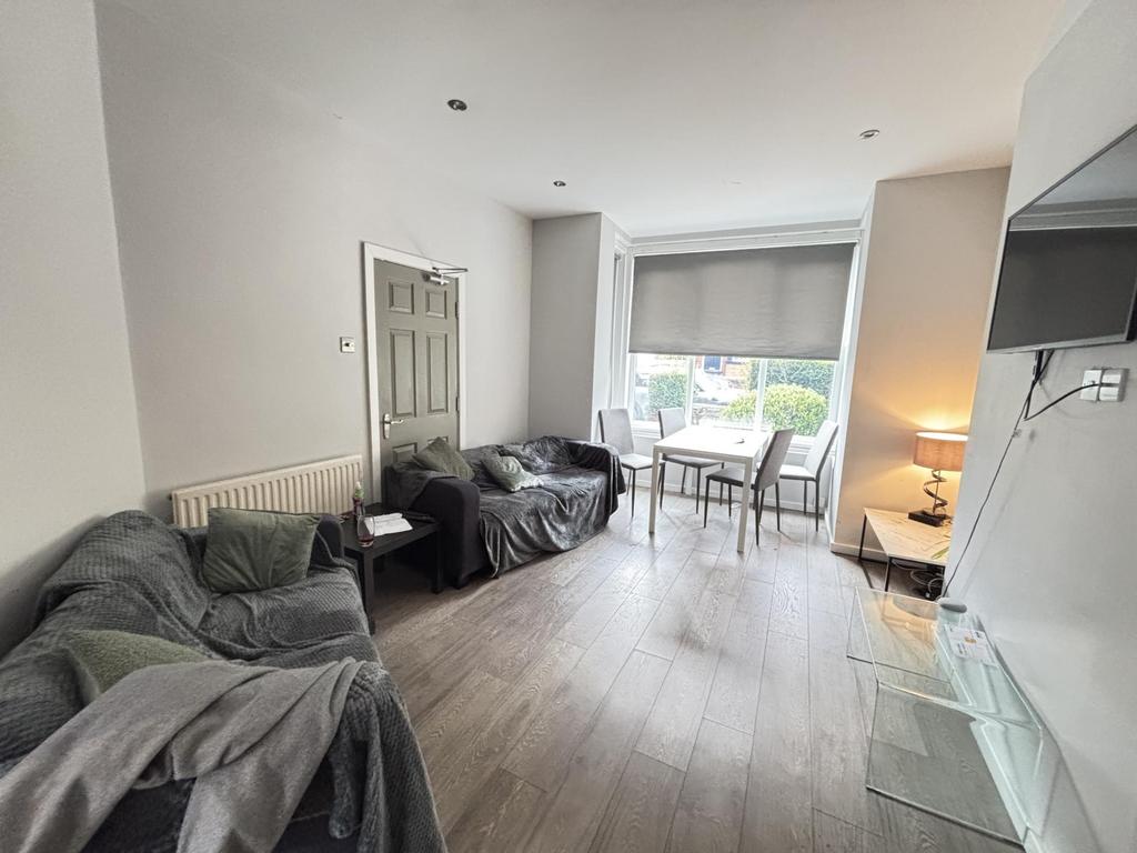 Bright and spacious living room featuring large...