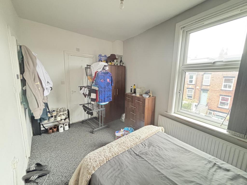 Bright and inviting bedroom with a large window...