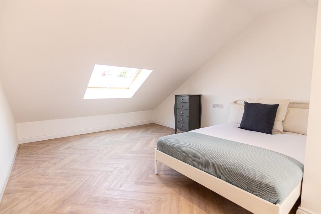 Bright and airy bedroom featuring a comfortable...