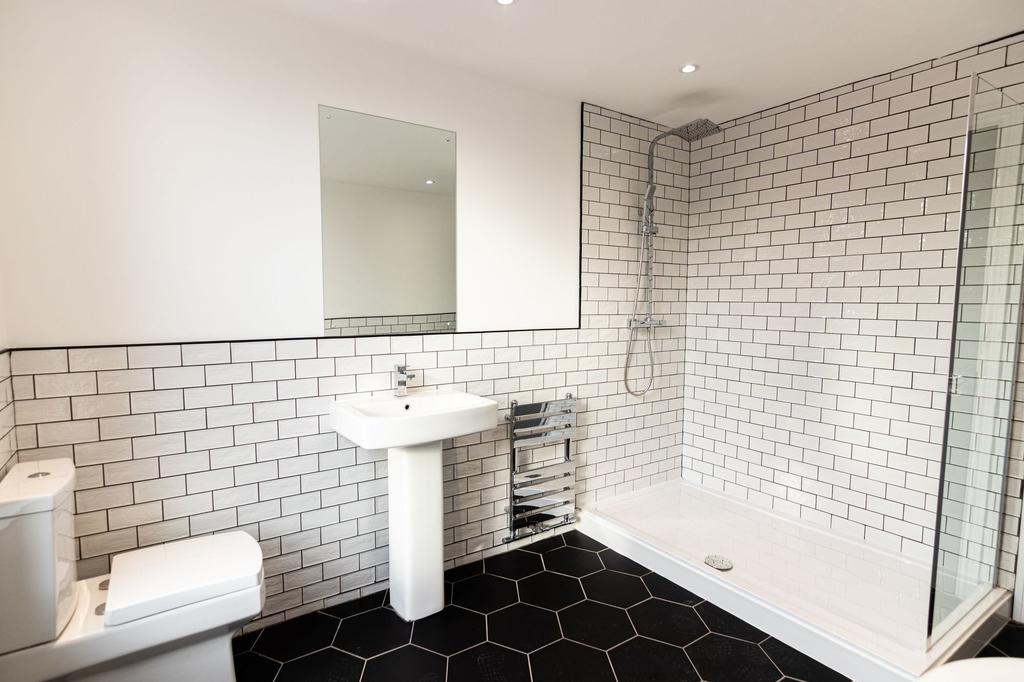 Modern and clean bathroom featuring white subwa...