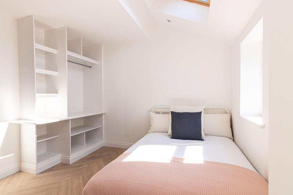 A bright and welcoming double bedroom featuring...