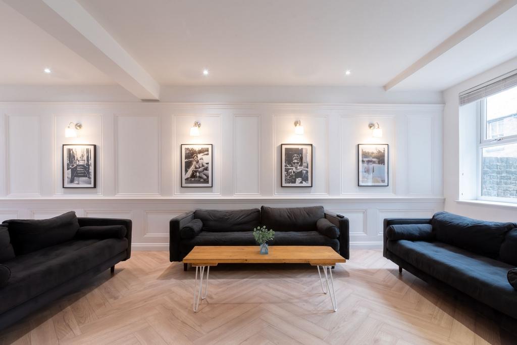 A bright, spacious living room featuring three ...