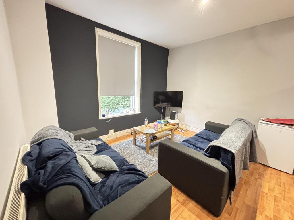 A modern and cozy living room with two sofas, a...