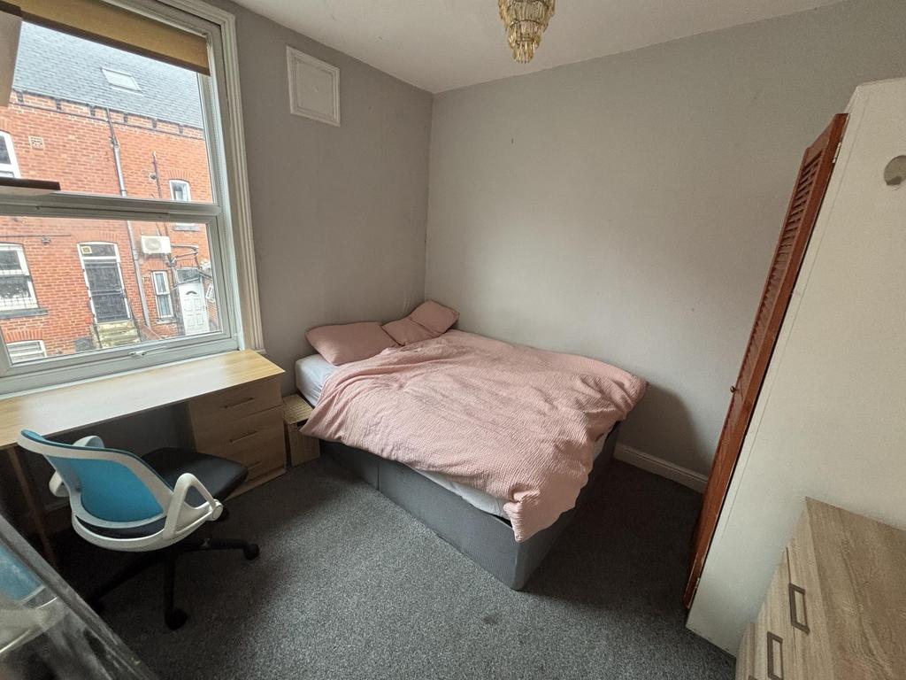 A tidy student bedroom featuring a double bed, ...