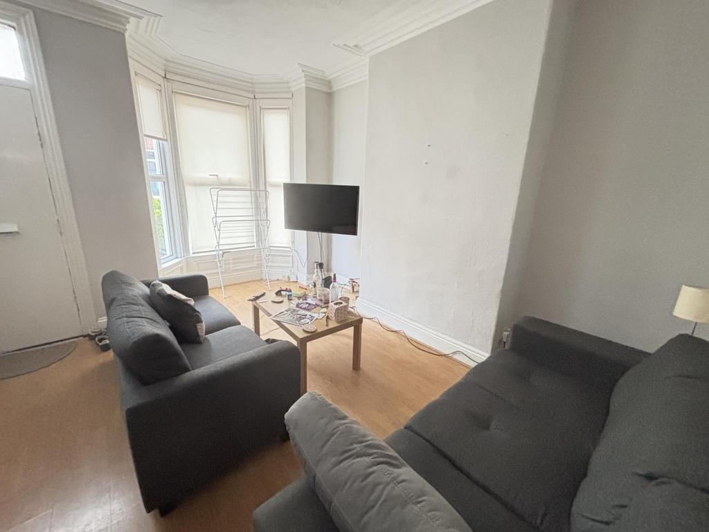 A bright and welcoming living room featuring tw...