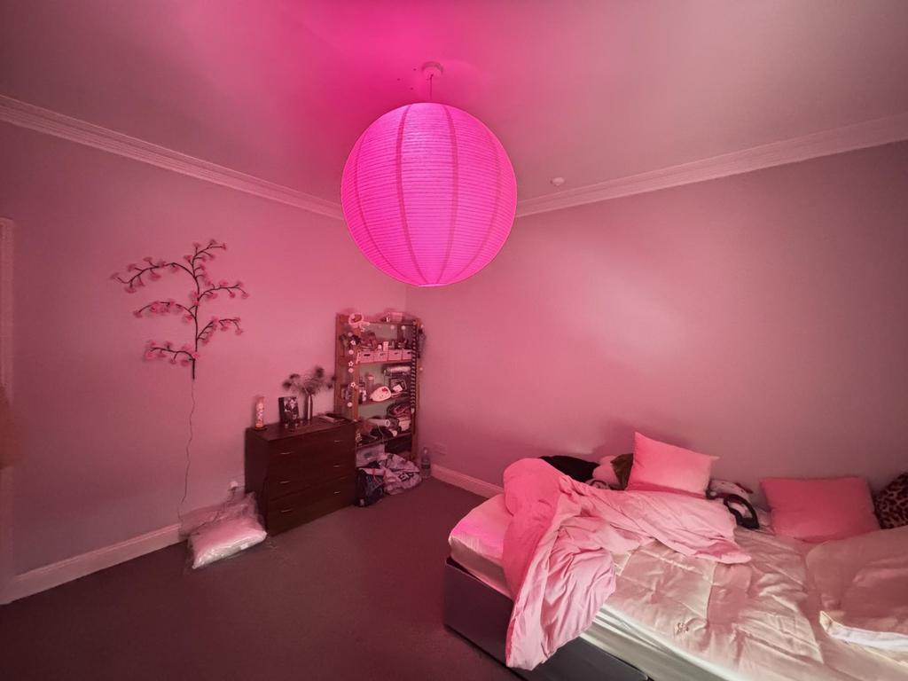 A spacious and bright master bedroom featuring ...