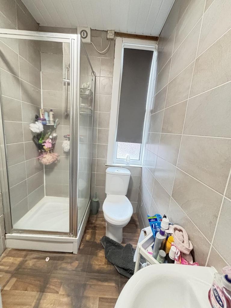 A well-maintained bathroom featuring a shower e...