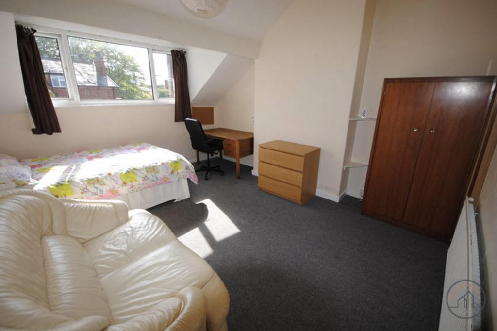 A cozy and well-lit bedroom featuring a single ...