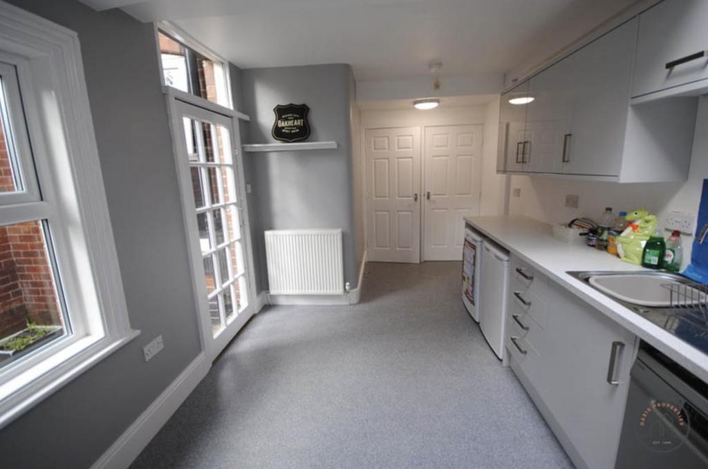 Bright and modern kitchen with ample natural li...
