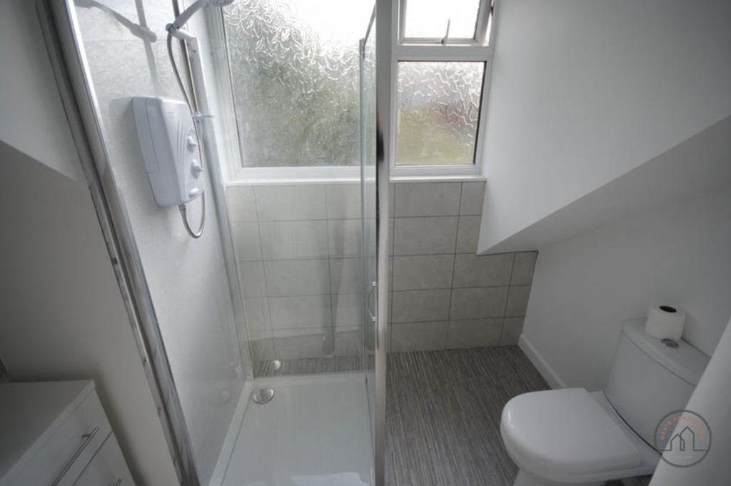 A clean, modern bathroom featuring a spacious s...