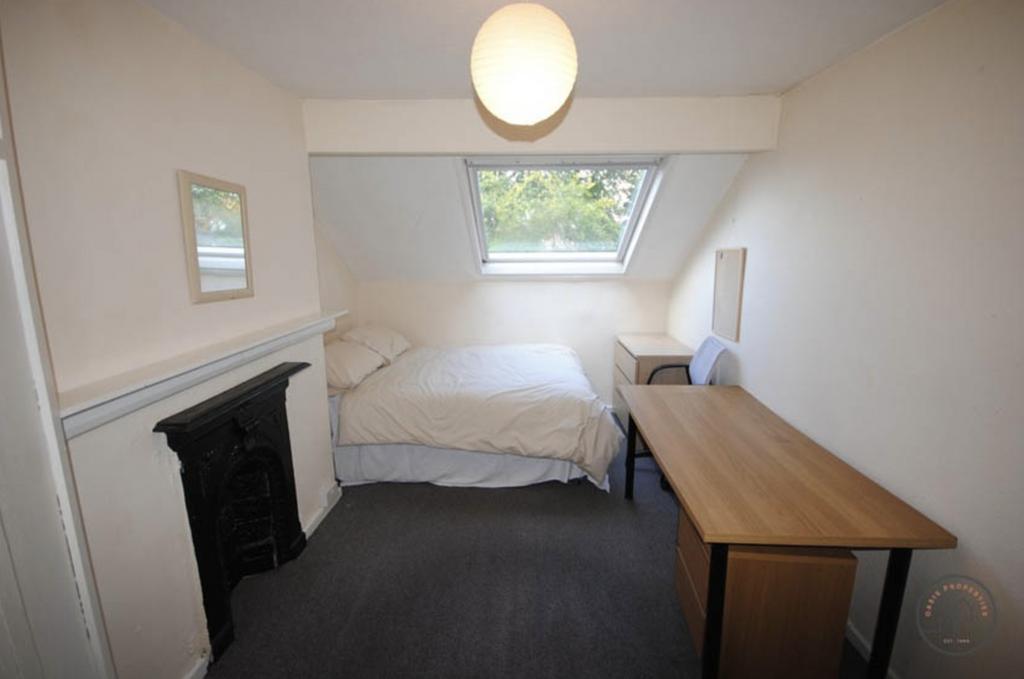 A cozy bedroom with a comfortable double bed po...