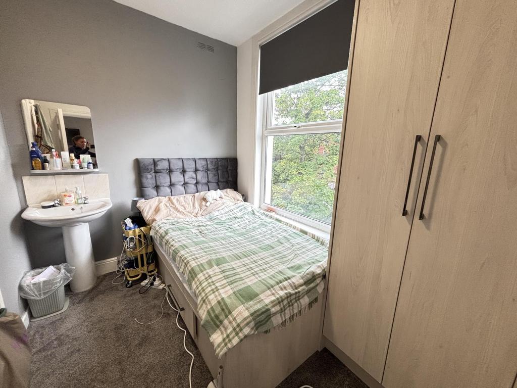 A cozy double bedroom featuring a neatly made b...