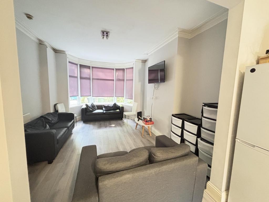 A spacious and well-lit living room with comfor...