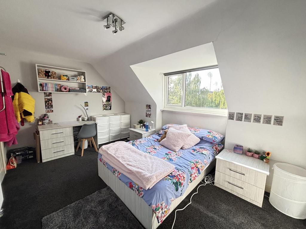 A cozy bedroom with a double bed, natural light...