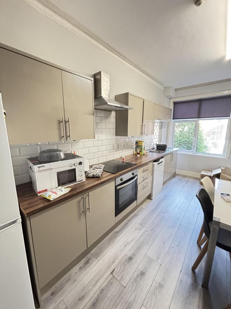 Bright and well-maintained kitchen with ample w...