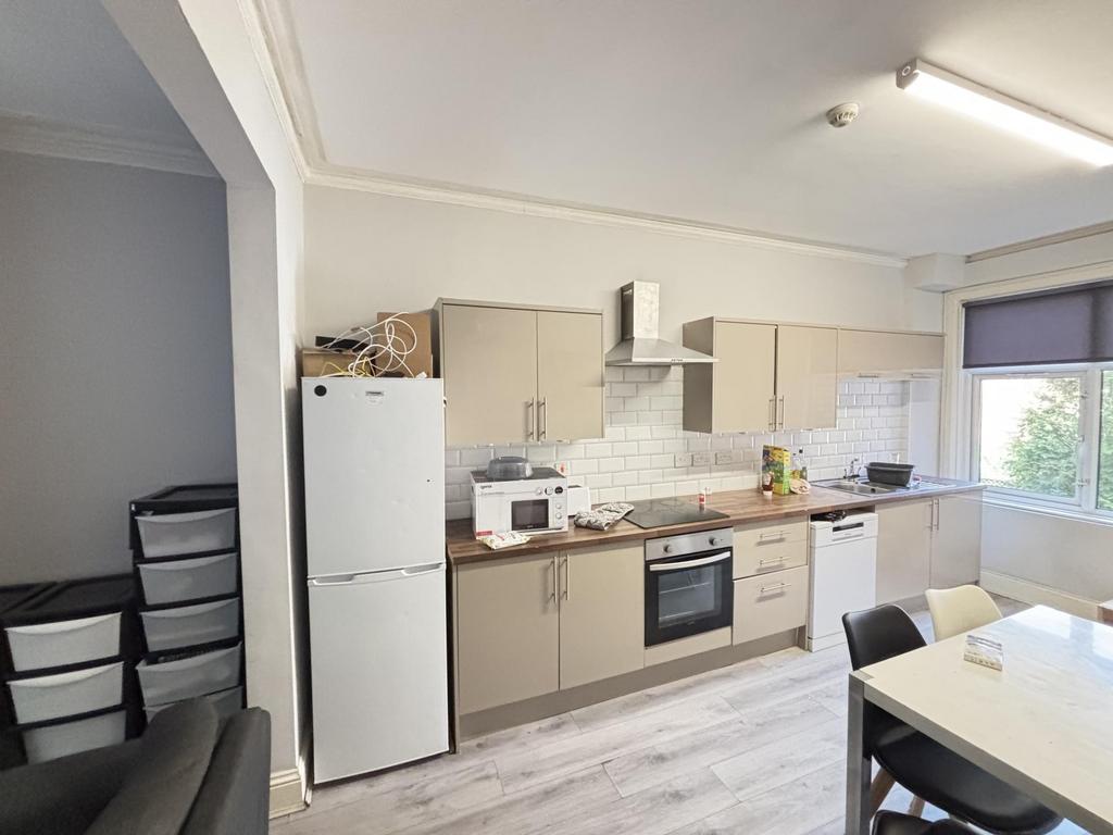 Modern kitchen area with ample natural light, f...