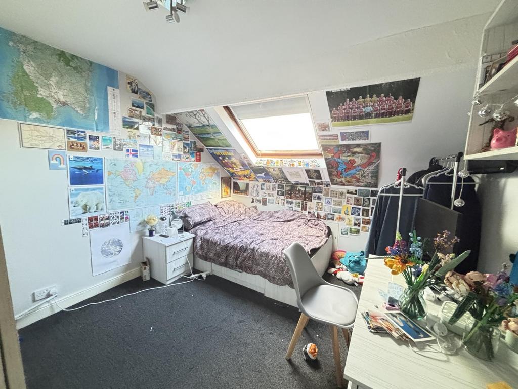 A cozy bedroom featuring vibrant wall decoratio...