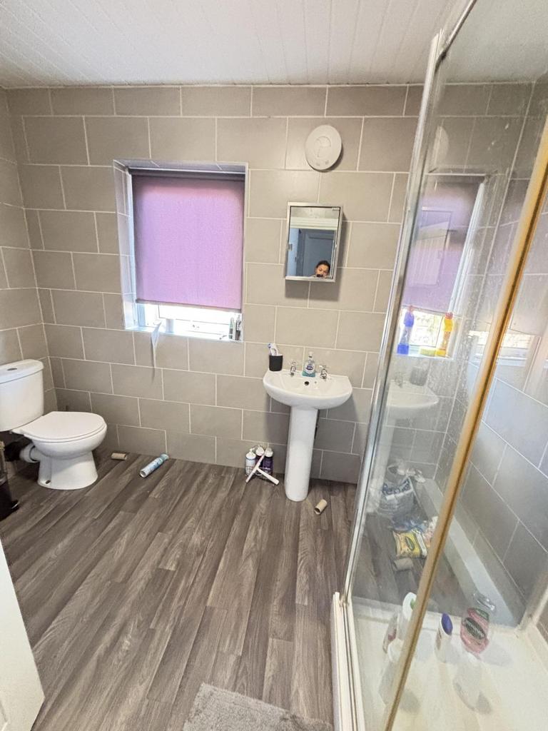 A bright and clean bathroom featuring a shower ...