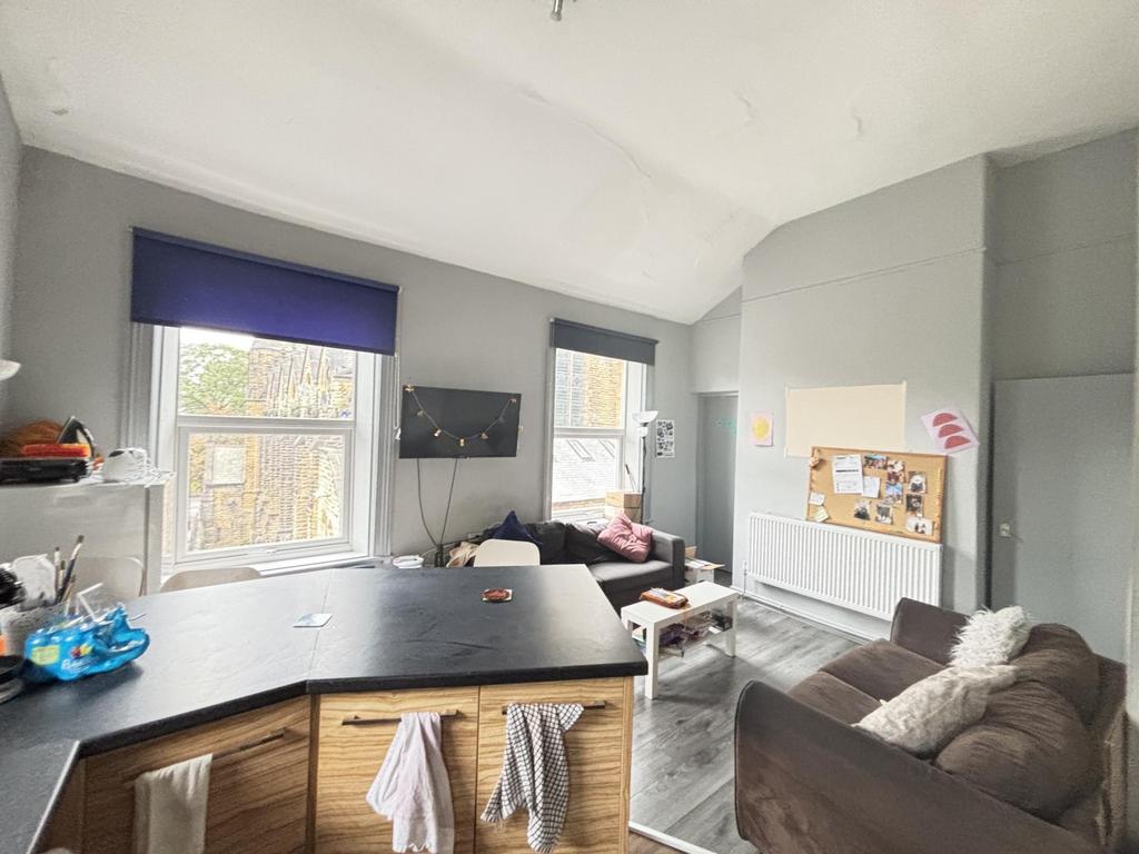 A well-lit and modern living room featuring lar...