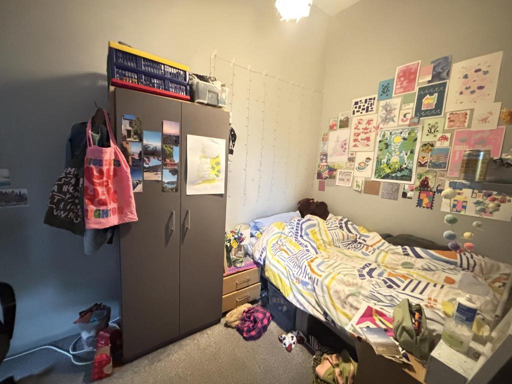A cozy bedroom with a single bed, decorated wit...
