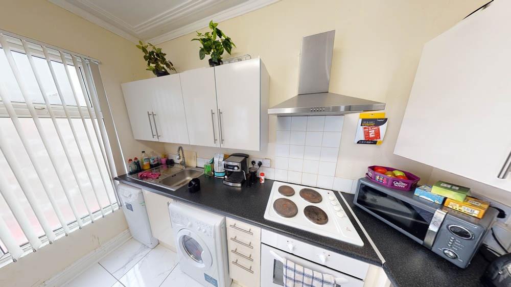 Bright and modern kitchen area with ample natur...