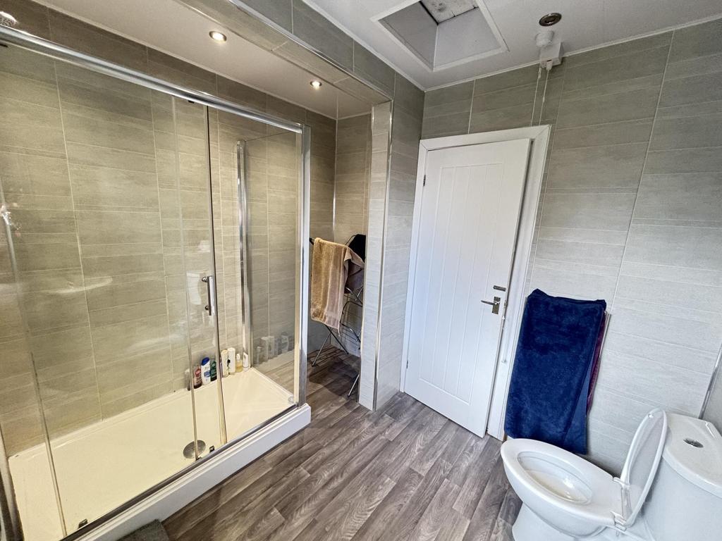 Clean and bright bathroom featuring a modern sh...