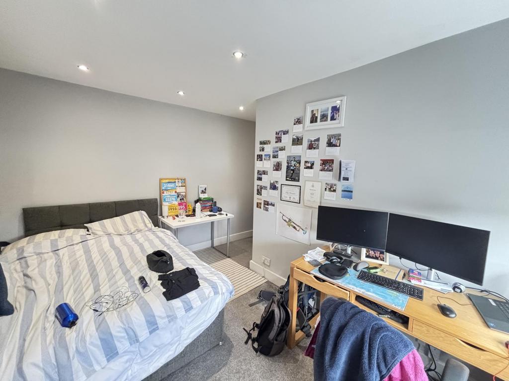 A well-maintained bedroom featuring a double be...