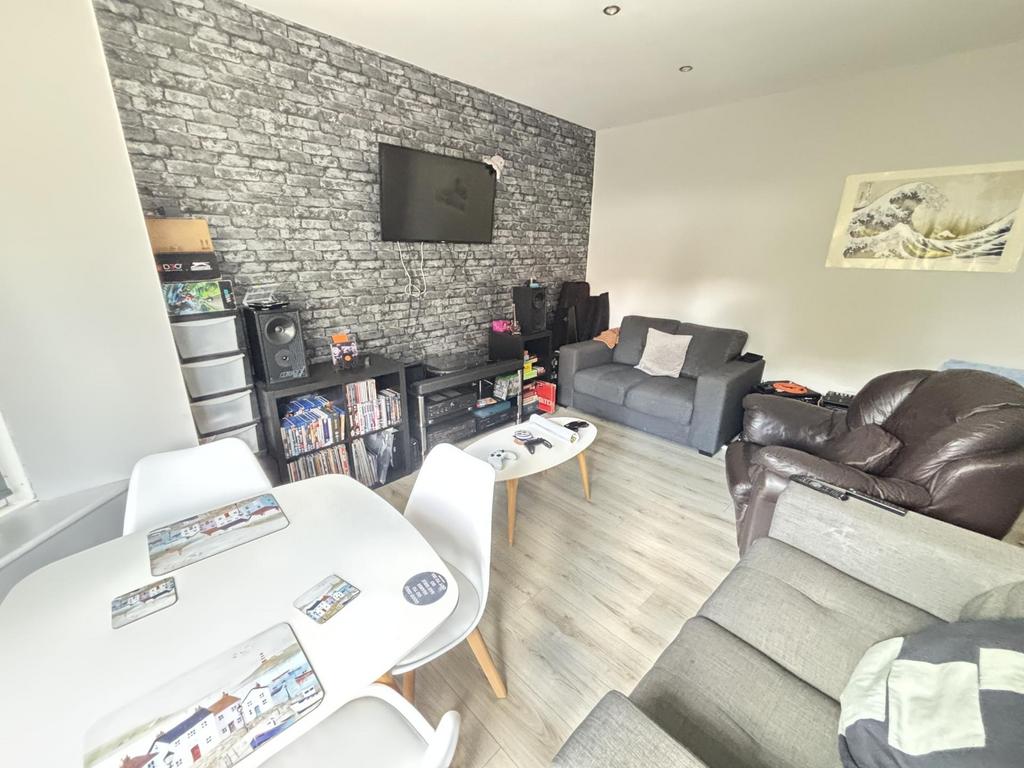 A spacious and modern living room featuring com...