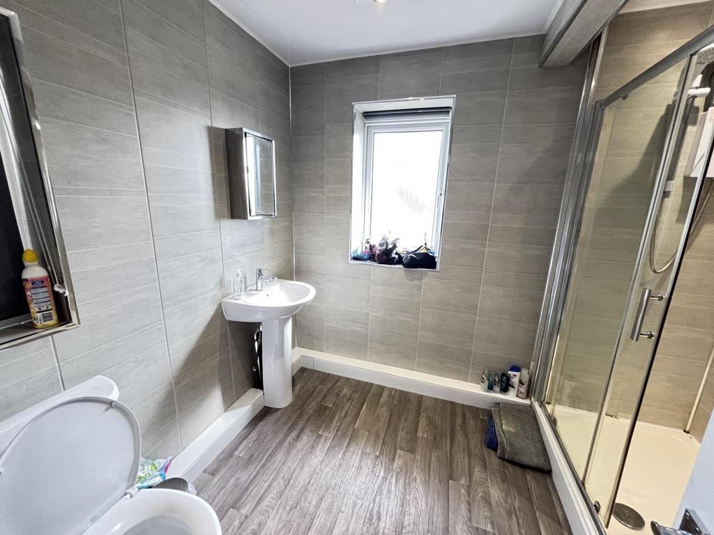 A modern, clean bathroom with ample natural lig...