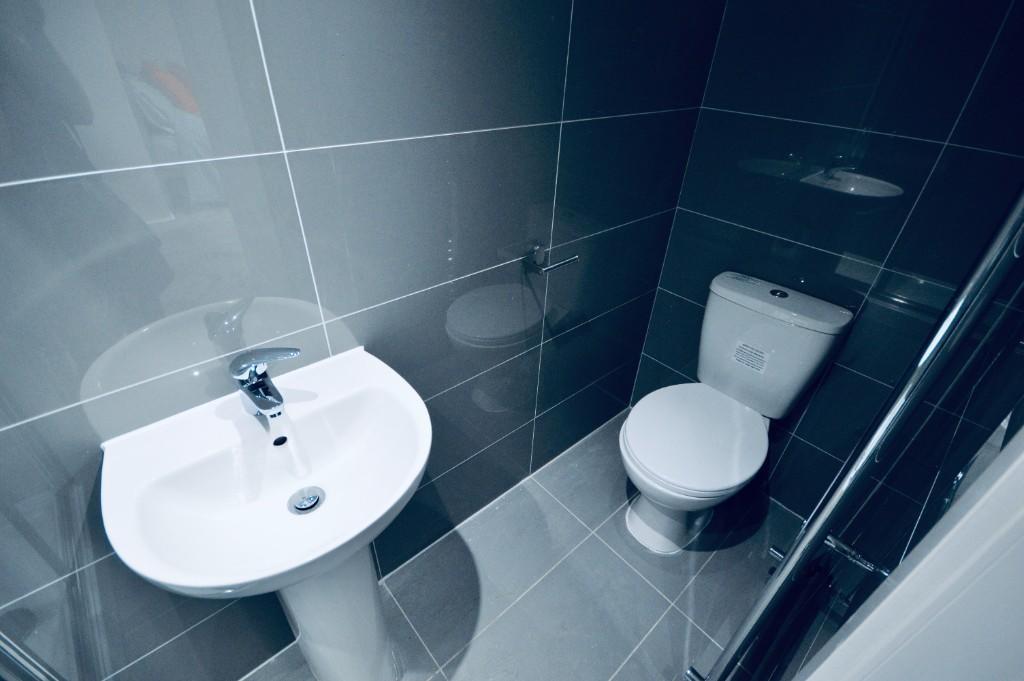 A modern and clean bathroom featuring a toilet ...