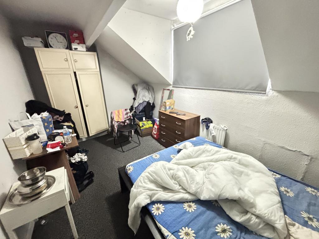 A cozy bedroom with a beds in place and a windo...