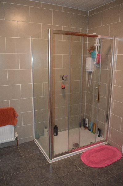 A clean and functional bathroom with a glass sh...