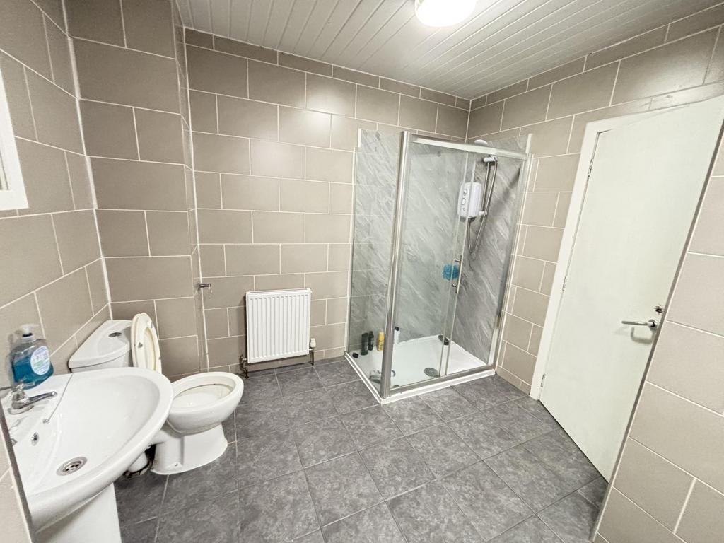 A clean, modern bathroom with a spacious shower...