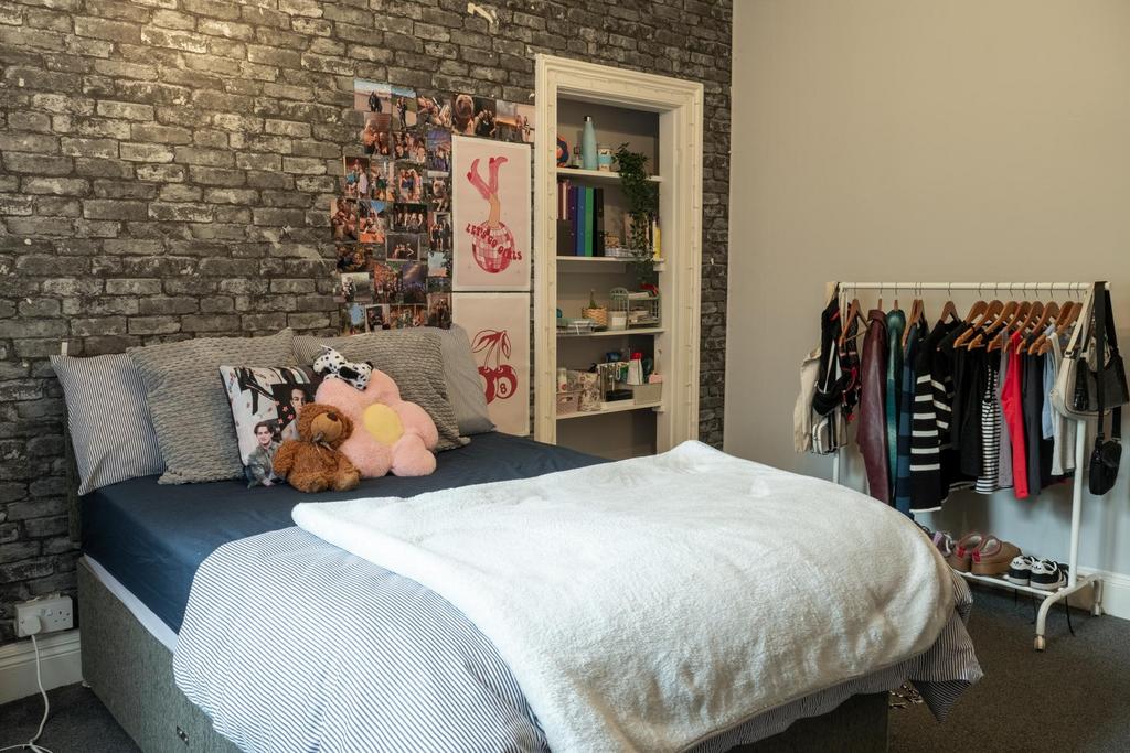 A cozy and well-maintained bedroom featuring a ...