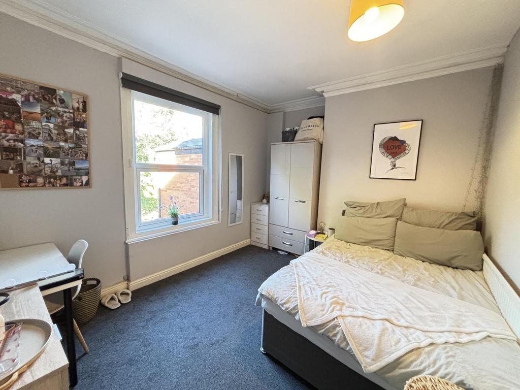 A well-maintained bedroom featuring a comfortab...