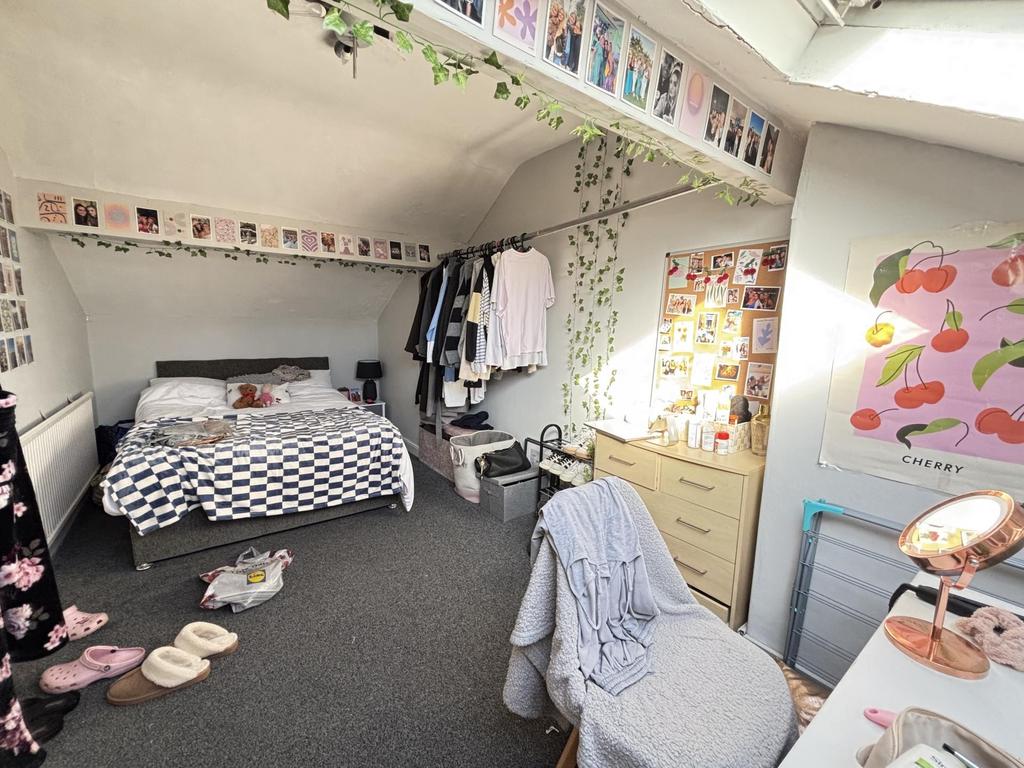 A cozy and bright bedroom with a comfortable be...